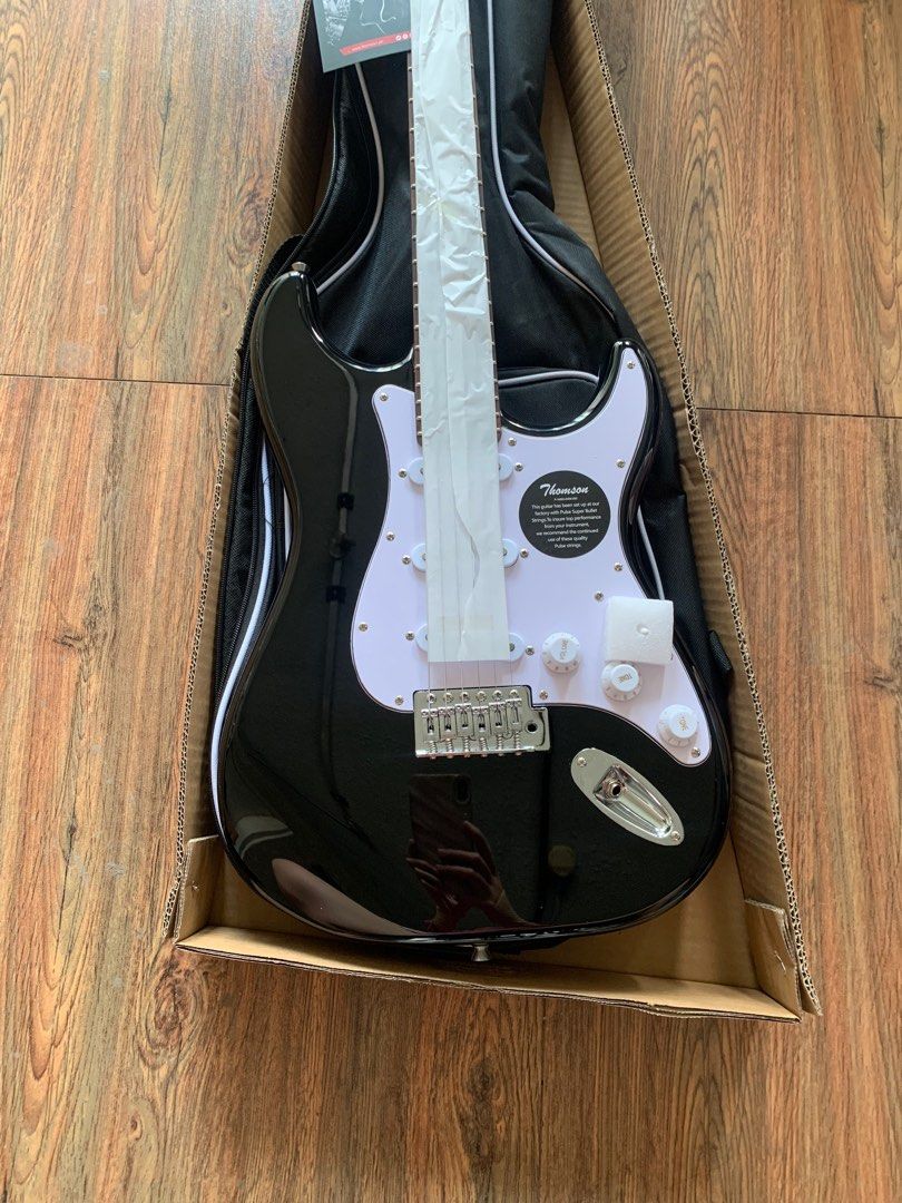 Thomson black stratocaster electric guitar (Category: Musical Instruments) located in Apalit. Submitted by angelic.archives (Listing ID 1353102317, Image 2). Description: PICK THIS UP AT ISKALA MUSIC STORE, APALIT, PAMPANGA 🎸THOMSON ST-1 stratocaster Thomson black stratocaster electric guitar 🎸BRANDNEW ELECTRIC GUITAR Fret: 22 Body: Solid Ash Wood Neck: Rosewood / Maple wood Fingerboard: Rosewood Pickup: S-S-S Controls:1V+2T Scale Length: 25-1/