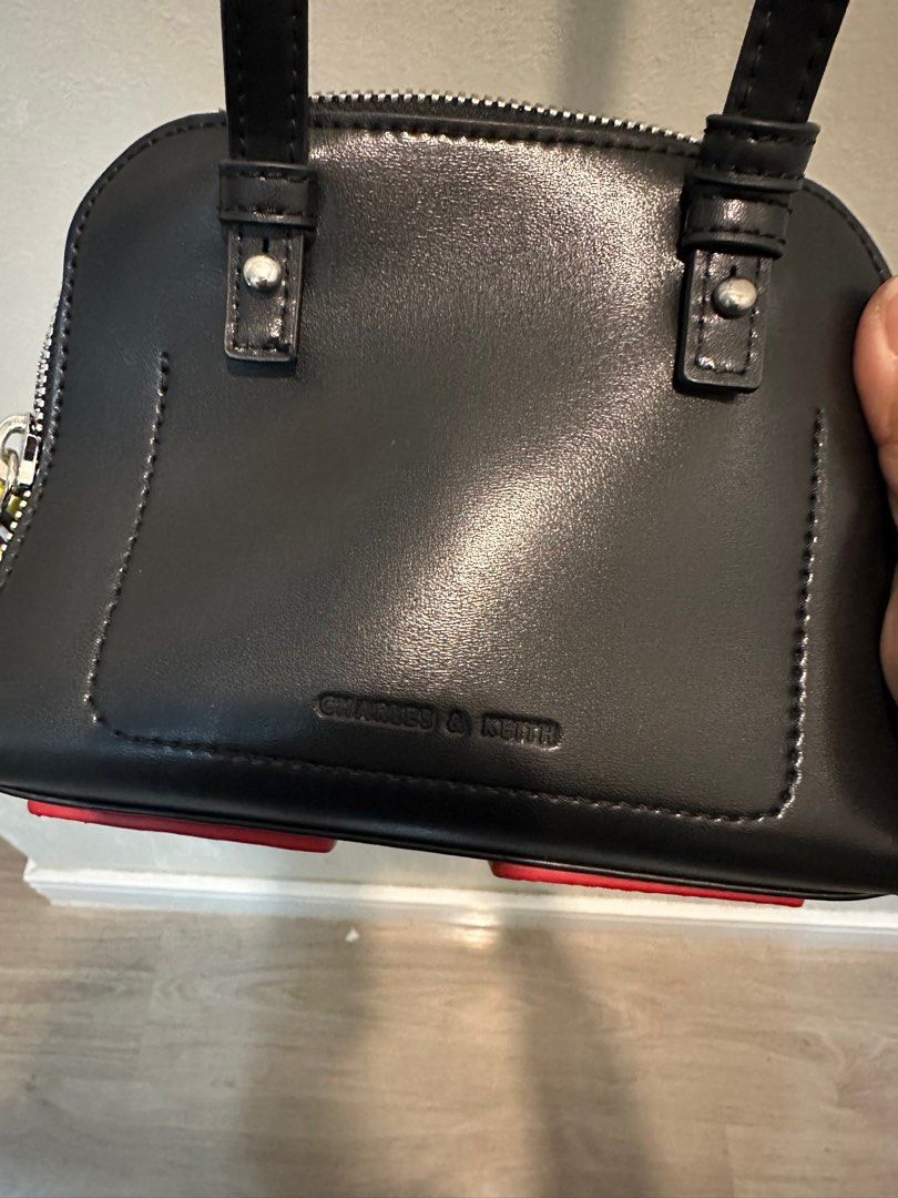 Charles & Keith Carey Crossbody Bag (Category: Cross-body Bags) located in Manila. Submitted by mal.eficent (Listing ID 1353390347, Image 3). Description: Authentic Charles & Keith Carey Crossbody Bag Size: Small Color: Black Bought in C&K SM Aura for 3k+ *Never get to use it. Too small for my stuff and abubuts* This is perfect for as your casual outfit accesories. The colorful charm details on the zipper is really an eye-catcher. Meetups in BGC 