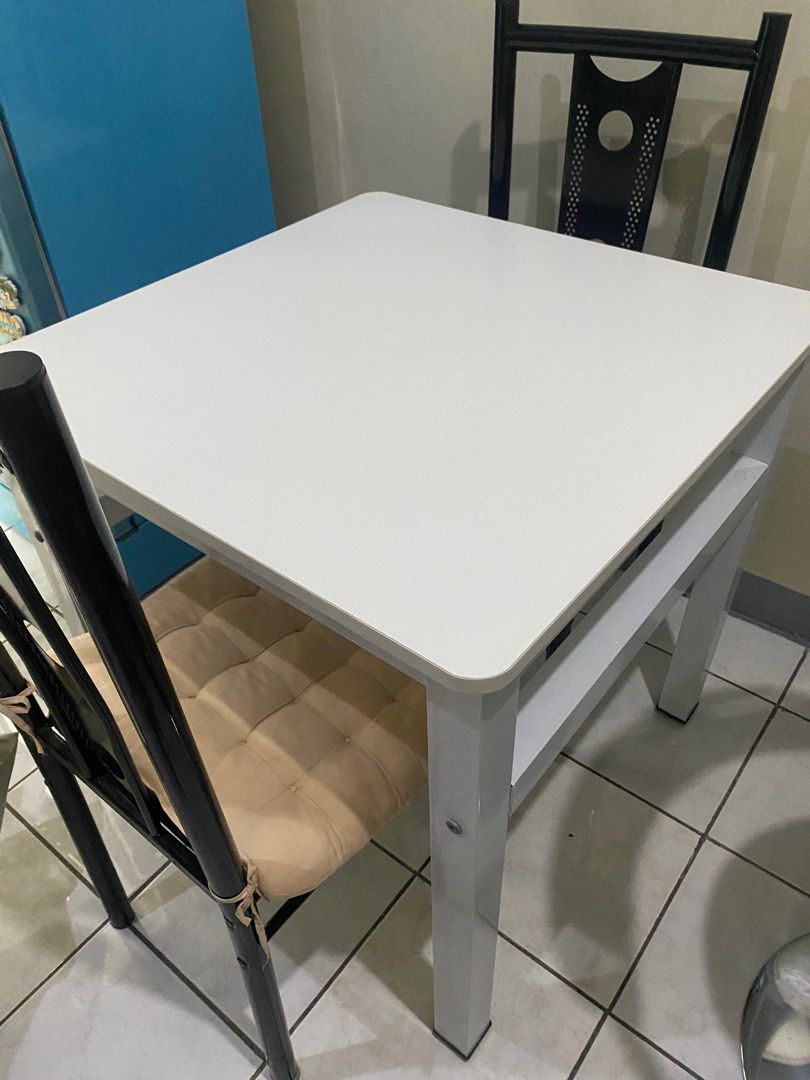 Dining Table (Pure WHITE) (Category: Other Kitchenware & Tableware) located in Mandaluyong City. Submitted by diamondzee (Listing ID 1353340449, Image 2). Description: Dining Table only Pure White Square 90x90 Good as new, no scratches High Quality Wood on top, and metal on feet 3K only.