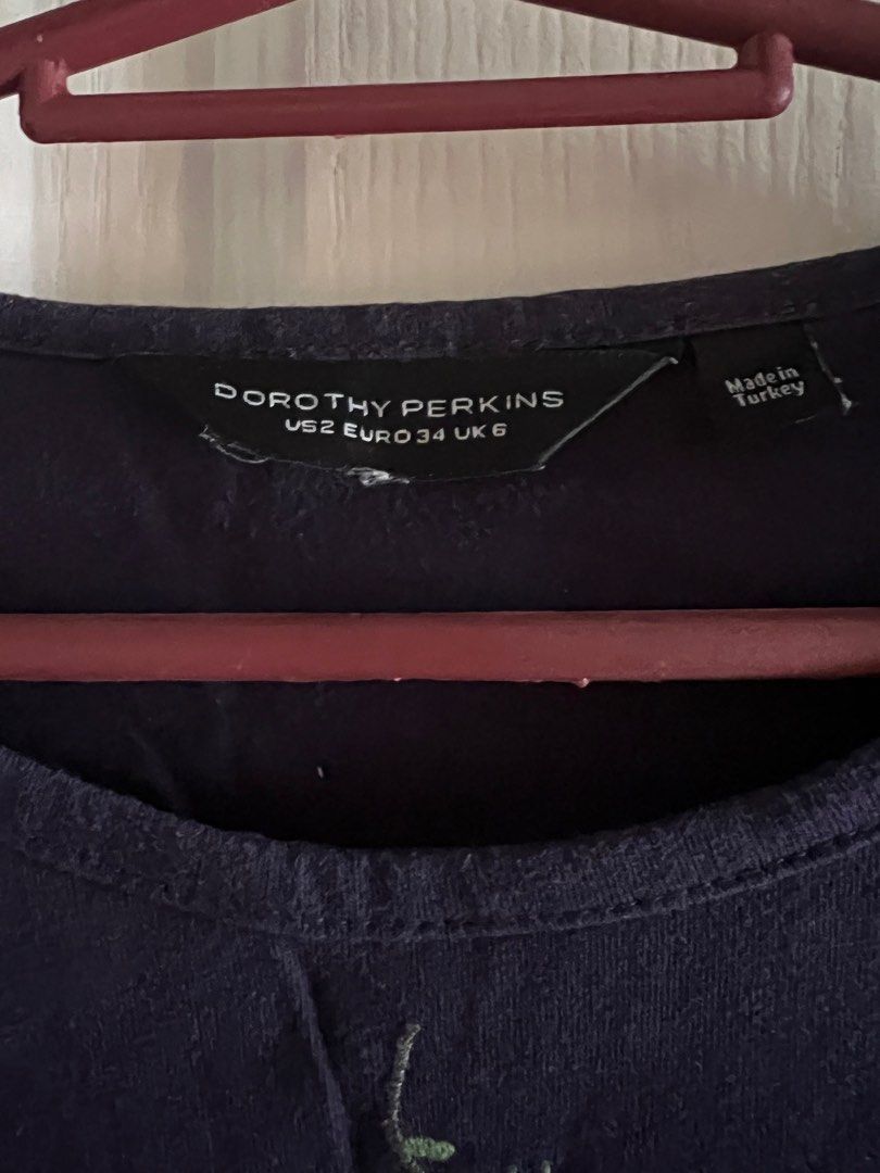 Dorothy Perkins navy blue top (Category: Blouses) located in Pasay City. Submitted by questionmart (Listing ID 1353323485, Image 2). Description: See flaw in 3rd and 4th pics - discoloration Bust 15-17” Length 24” .