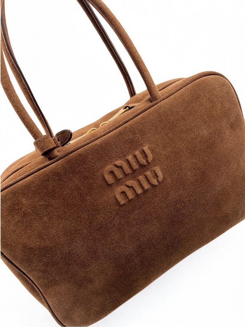 ⚜️Miu Miu Beau Bag - Suede (Category: Luxury Bags & Wallets) located in Makati City. Submitted by 90sangel (Listing ID 1353238280, Image 3). Description: •Item: The iconic Beau bag of Miu miu. •Size: One size - 23cm x 34 x 10 For those who aren't aware, Miu Miu is the sister brand of PRADA ⚜️🖤 This Beau bag features handles, a soft touch, and a luxurious suede texture..