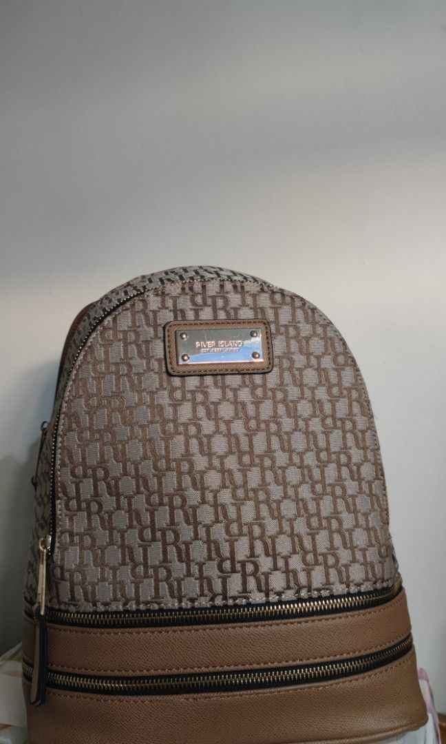 River Island Brown Ri Monogram Print Jacquard Backpack Bag (Category: Backpacks) located in Antipolo. Submitted by kkpunzln (Listing ID 1353240288, Image 3). Description: good as new, i used it twice only. original price is around 28 pounds (2k pesos) rfs: need funds.