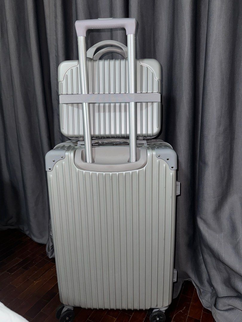 Gray/silver luggage set (Category: Luggage) located in Pasay City. Submitted by iamtrustworthy (Listing ID 1353767224, Image 3). Description: Luggage: Length vertical 21inches Length diagonal 25inches Width 15inches Depth 9 inches Mini luggage: 12L x 9W x 5.5D inches.