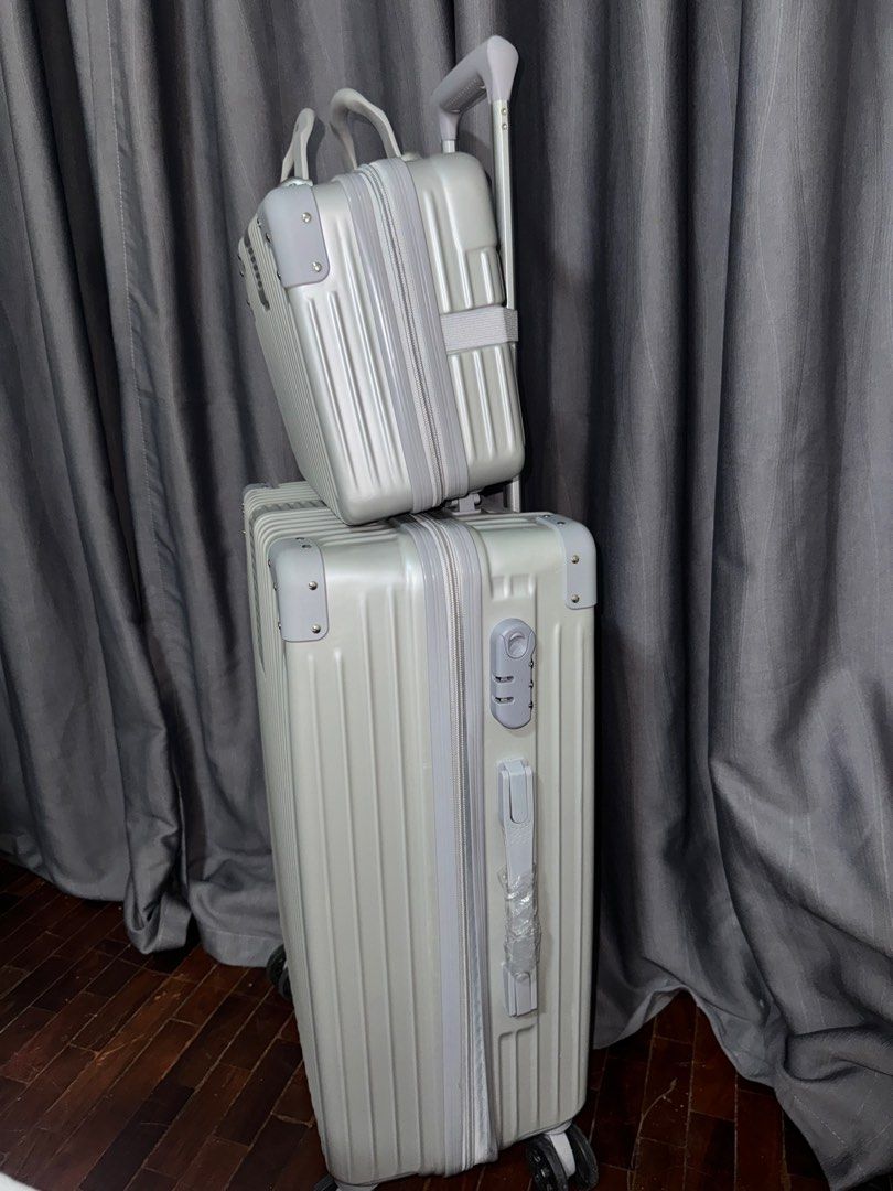 Gray/silver luggage set (Category: Luggage) located in Pasay City. Submitted by iamtrustworthy (Listing ID 1353767224, Image 2). Description: Luggage: Length vertical 21inches Length diagonal 25inches Width 15inches Depth 9 inches Mini luggage: 12L x 9W x 5.5D inches.