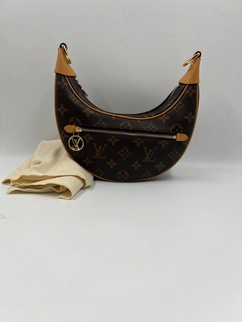 LV Loop Monogram Canvas (Category: Luxury Bags & Wallets) located in Manila. Submitted by shopkioneph (Listing ID 1353759004, Image 3). Description: ***Japan Preloved*** Created by Nicolas Ghesquière for the Cruise 2022 Collection, the Loop handbag features a half-moon silhouette, inspired by the Croissant bag from the House archives. It has a body-friendly, compact shape and a chain for shoulder carry, as well as a cross-body leather strap. The 