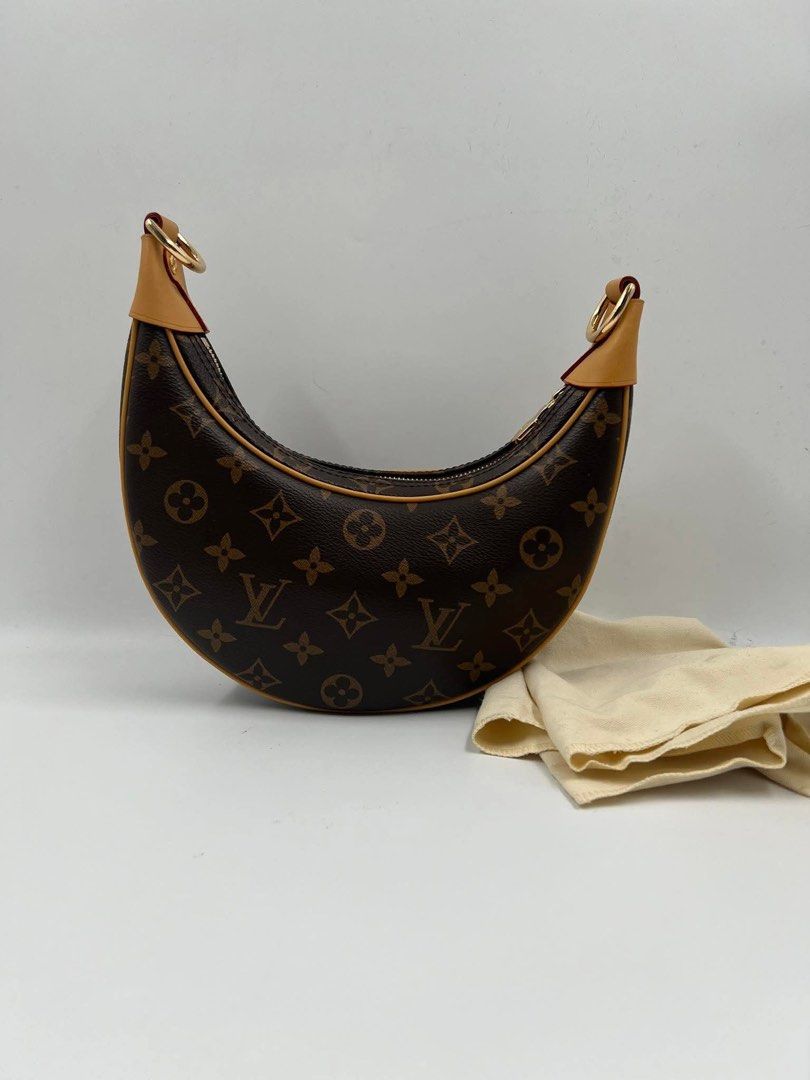 LV Loop Monogram Canvas (Category: Luxury Bags & Wallets) located in Manila. Submitted by shopkioneph (Listing ID 1353759004, Image 1). Description: ***Japan Preloved*** Created by Nicolas Ghesquière for the Cruise 2022 Collection, the Loop handbag features a half-moon silhouette, inspired by the Croissant bag from the House archives. It has a body-friendly, compact shape and a chain for shoulder carry, as well as a cross-body leather strap. The 