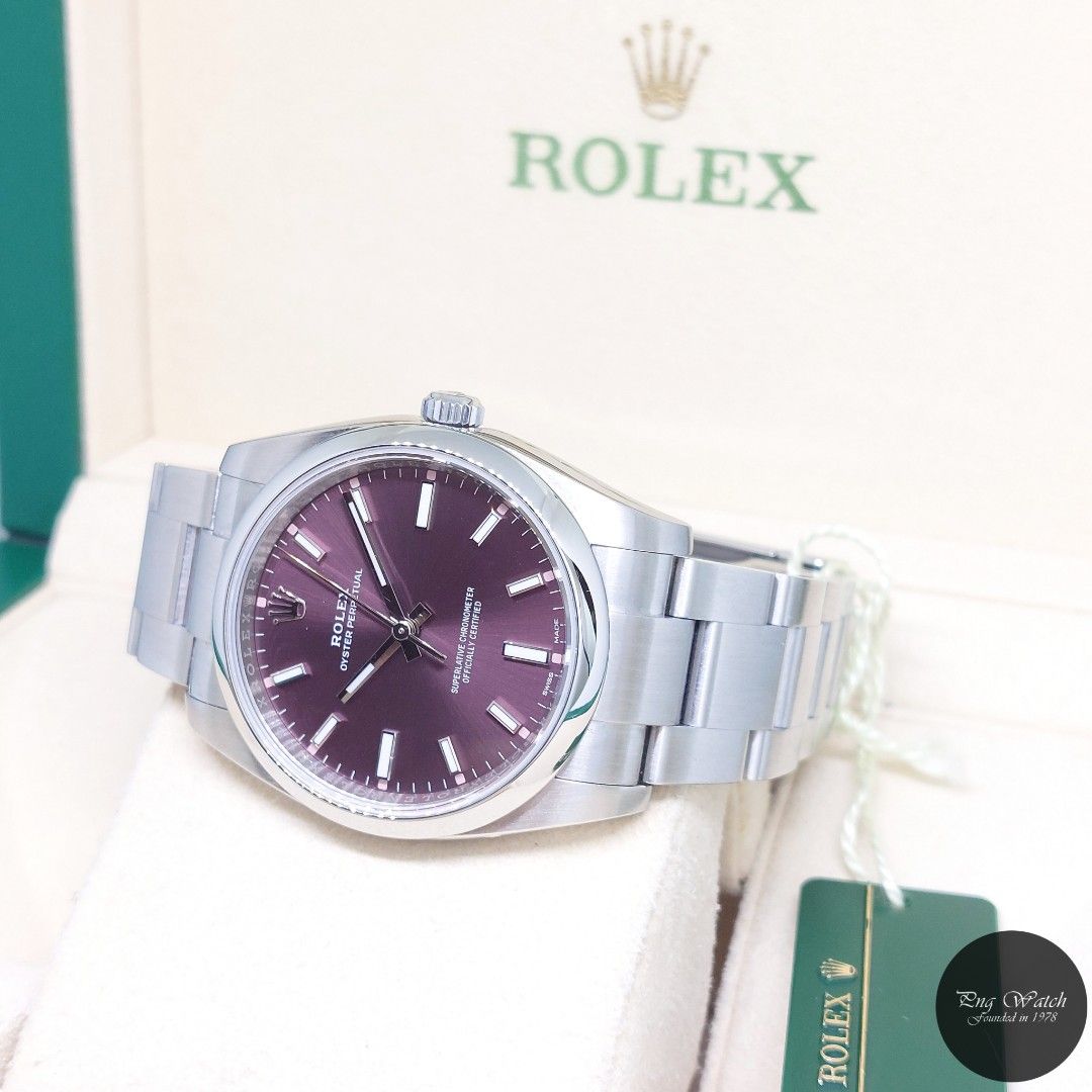 Rolex 34mm Purple Indexes Dial Oyster Perpetual REF: 114200 (2015) (Category: Watches) located in Singapore. Submitted by pngwatchdealer (Listing ID 1353766299, Image 2). Description: [SPECIFICATIONS] **Watch comes in full option (Box, Card & Tag)** Brand: Rolex Model: Oyster Perpetual (REF: 114200)(AN)(15)(O) Movement: Automatic (Self-Winding) Functions and Features: Hours, Minutes and Seconds (CASE) Case Material: Stainless Steel Case Diameter: