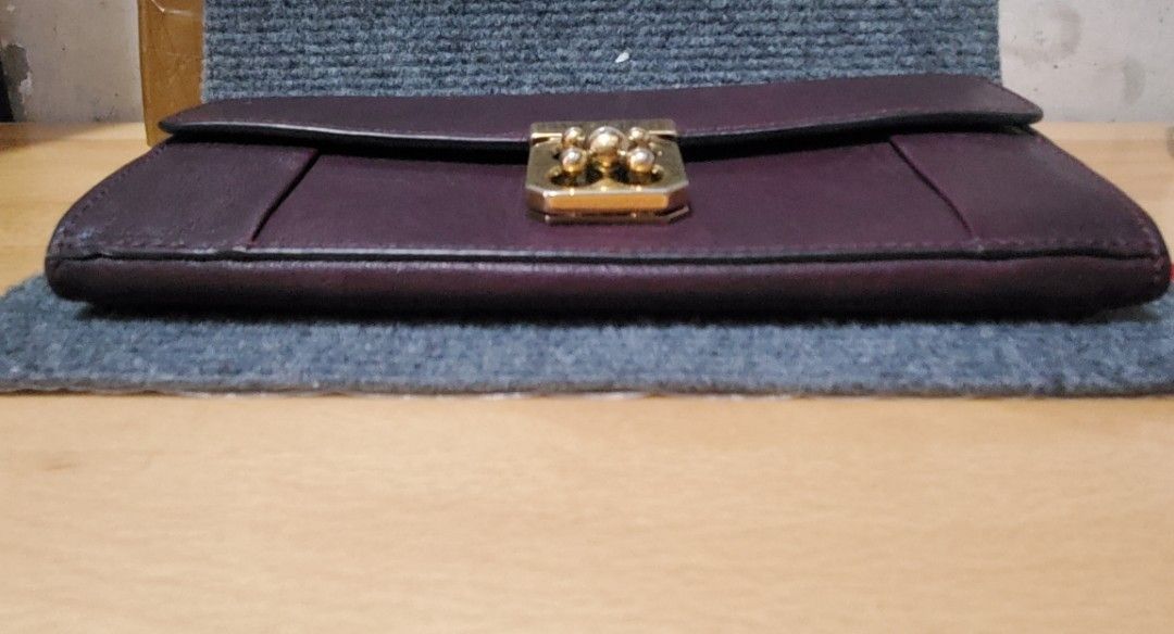 Authentic Chloe leather wallet (Category: Luxury Bags & Wallets) located in Taytay. Submitted by xismart (Listing ID 1353900262, Image 2). Description: Authentic Chloe long wallet. color: Mahogany ( dark rich wine color) hardware: gold many compartments for cards. soft leather. light signs of usage. no rubs. stain in one of the compartments but it looks like it can be washed off. super duper pretty and elegant. shipping fee c/o buyer.
