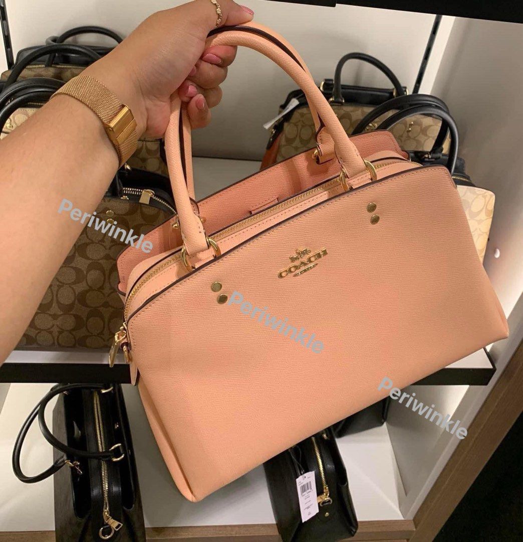 Coach Lillie carryall pink (Category: Luxury Bags & Wallets) located in Manila. Submitted by peri_winkle (Listing ID 1350760441, Image 1). Description: Coach Lillie Caryall bag Color: Shell pink Comparable value: $428.00 or P25,000 Last pic color is different due to lighting No paper bag.
