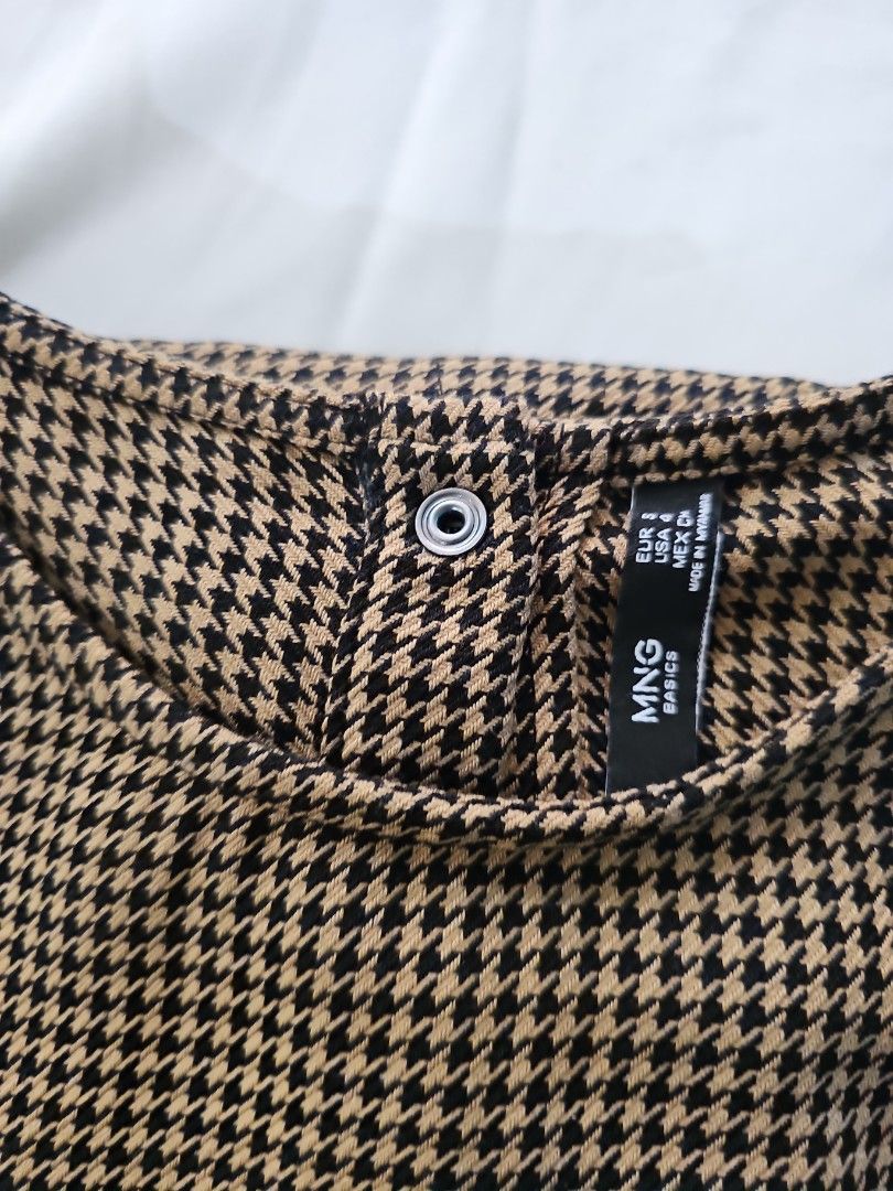 Mango Houndstooth Blouse (Category: Blouses) located in Paranaque City. Submitted by shopextraph (Listing ID 1350739691, Image 3). Description: [Pre-owned] MNG By Mango Basics Houndstooth Blouse Featuring a trendy houndstooth print in brown and black, this long sleeve blouse is perfect for any occasion. The round neck and basic style give it a classic touch, while the polyester and viscose material ensure comfort and durability. Size EU Small, US