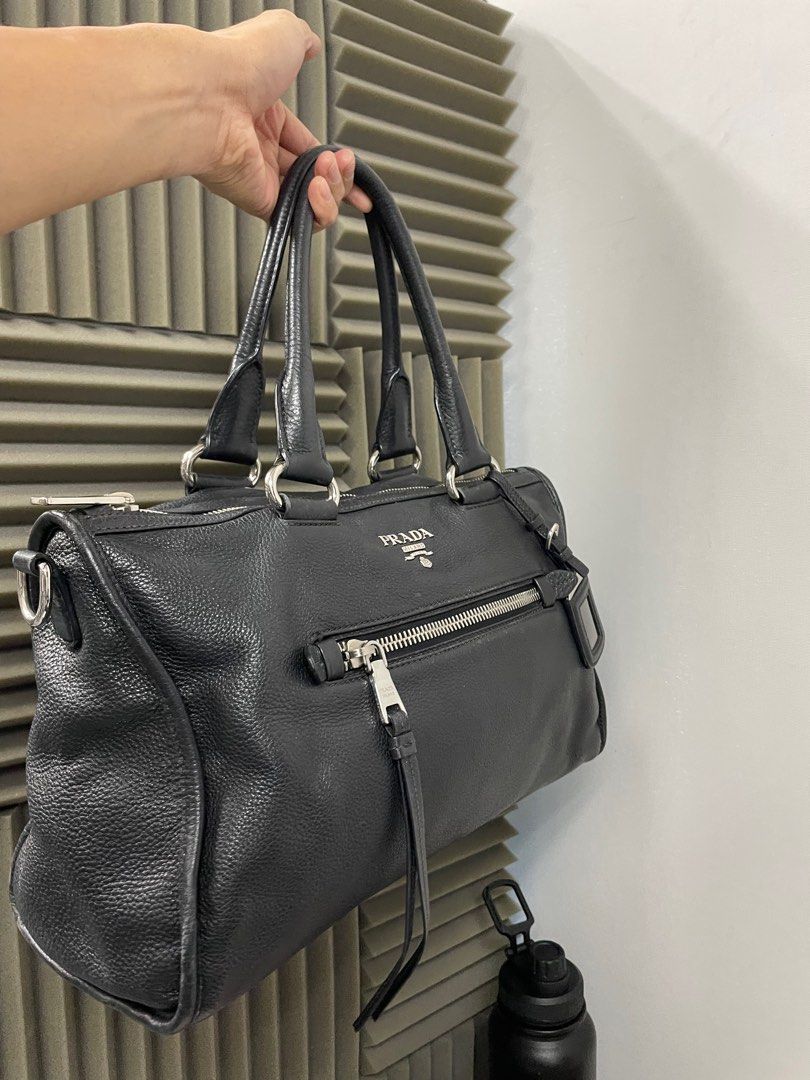 PRADA Black Vitello Phenix Leather Zip Tote Bag (Category: Luxury Bags & Wallets) located in Manila. Submitted by luxemax_09 (Listing ID 1354041072, Image 2). Description: Gender: Ladies’ Material: Vitello daino leather Stamp: BL0805/165 Interior: One zipper compartment with One zipper pocket and One open pocket Measurements: 15”L X 6”W X 9”H Handle Drop: 6” Hardware: Silver tone Inclusions: Removable strap .