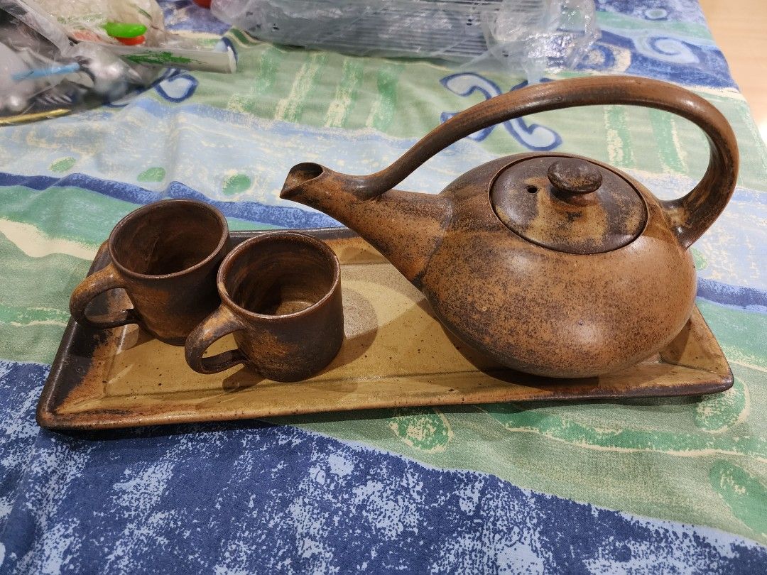 Stoneware teapot set with tray (Category: Coffee & Tea Tableware) located in Makati City. Submitted by kanixa (Listing ID 1354388120, Image 1). Description: Nice rustic brown color. Tray 33.5cm x 13cm 2 teacups 5cm in height, 5.5cm in diameter Teapot with cover (quite heavy) 21cm in length, 14cm in height Given as a gift, never used, just stored in closet..