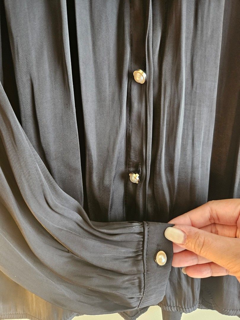 Black Long Sleeves Blouse with Pearl Buttons (Category: Longsleeves) located in Mandaluyong City. Submitted by maeemp (Listing ID 1354530464, Image 2). Description: Elegant Black Satin-Like Blouse with Pearl Buttons ✨ 📏 Size: Fits L-XL 🔹 Features: 🌟 Elegant satin-like fabric with a soft sheen 🖤 Classic black, easy to dress up or down 💎 Statement pearl buttons on the front and cuffs 💃 Flowy, loose fit with a slight A-line cut for effortless 