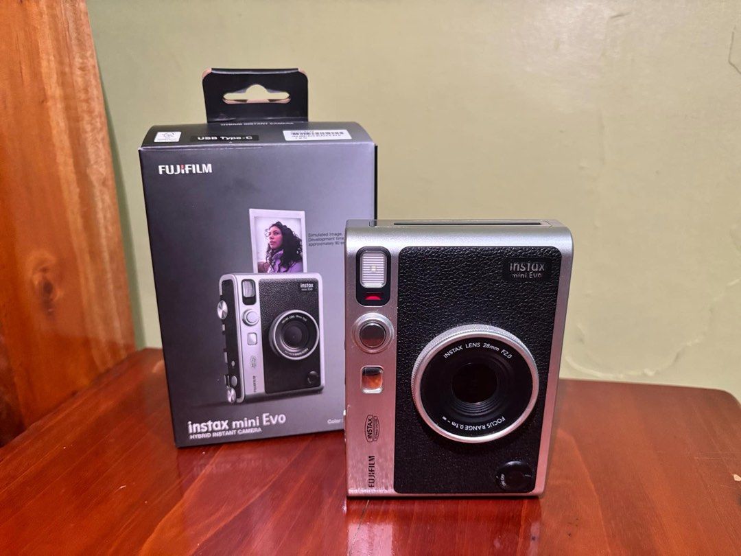 Instax Mini Evo (Black) (Category: Cameras) located in Calamba. Submitted by duckboy_03 (Listing ID 1354645784, Image 1). Description: instax mini evo (black) occasionally used issue: signs of use (minimal scratches that doesn't affect the performance) inclusions: box, strap, wire/charging chord, manual rfs school funds.