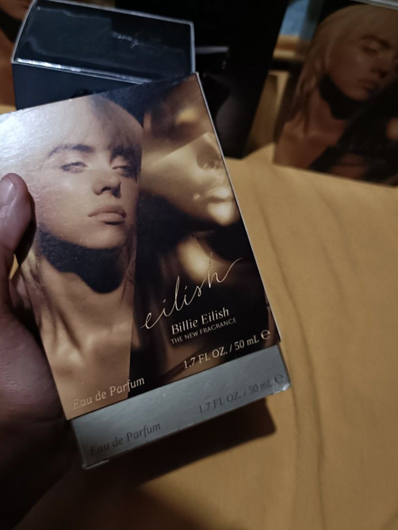 ORIGINAL Eilish by Billie Eilish 50ml (GOLD, NO. 1) (Category: Fragrance & Deodorants) located in Pasay City. Submitted by declutterwifmeee (Listing ID 1354800302, Image 3). Description: Eilish is a captivating Amber Gourmand featuring notes of sugared petals, creamy vanilla, and warm musks. Top Notes Red Berries, Mandarin, Sugared Petals Middle Notes Vanilla Bourbon, Soft Spices Accord, Cocoa Base Notes Warm Musk, Creamy Woods, Tonka -50 ml bott