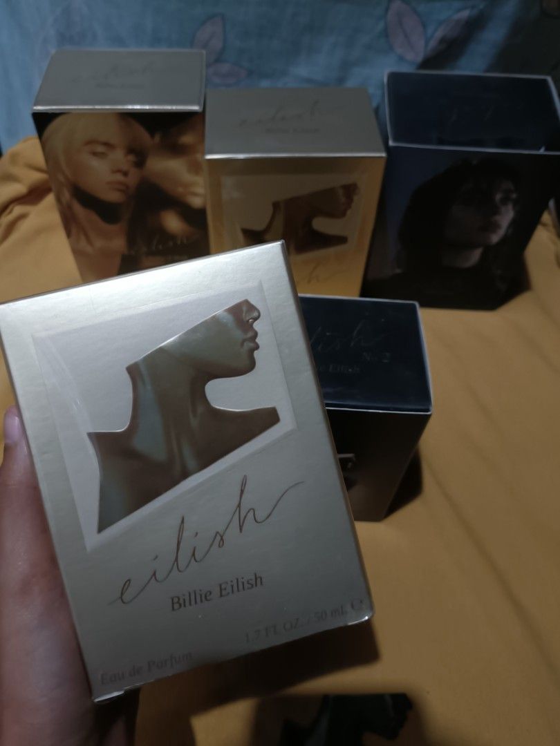 ORIGINAL Eilish by Billie Eilish 50ml (GOLD, NO. 1) (Category: Fragrance & Deodorants) located in Pasay City. Submitted by declutterwifmeee (Listing ID 1354800302, Image 1). Description: Eilish is a captivating Amber Gourmand featuring notes of sugared petals, creamy vanilla, and warm musks. Top Notes Red Berries, Mandarin, Sugared Petals Middle Notes Vanilla Bourbon, Soft Spices Accord, Cocoa Base Notes Warm Musk, Creamy Woods, Tonka -50 ml bott