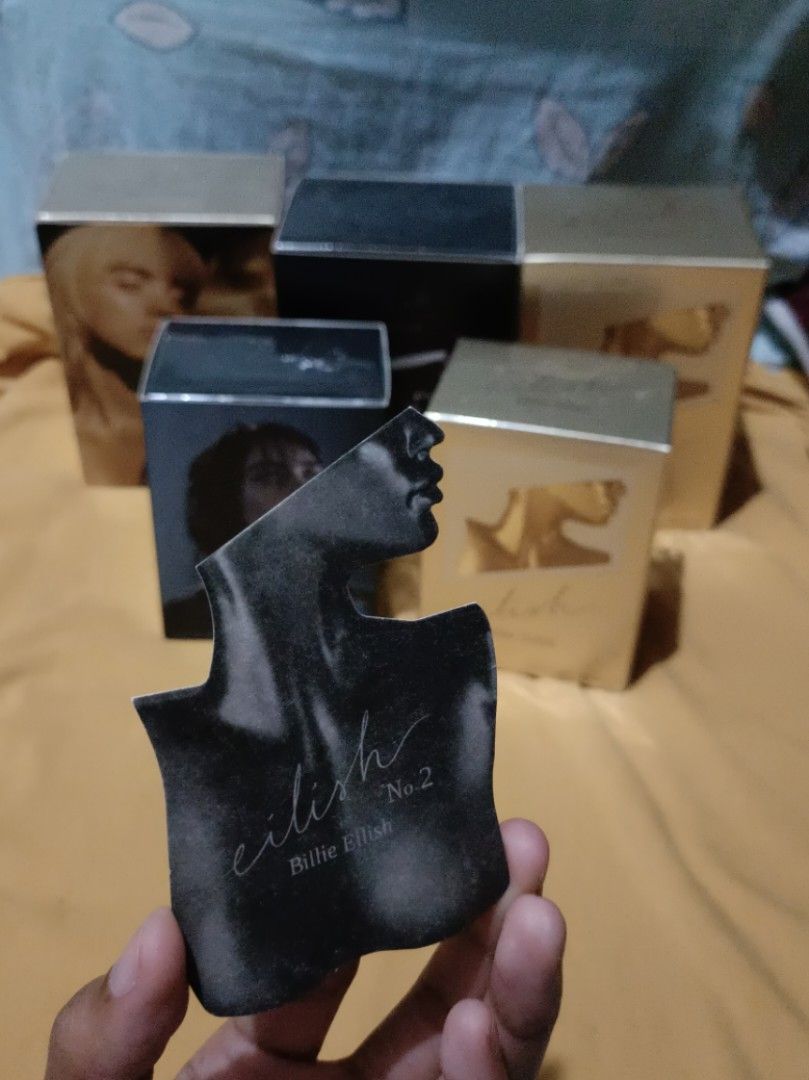ORIGINAL Eilish by Billie Eilish 100ml (GOLD, NO. 1) (Category: Fragrance & Deodorants) located in Pasay City. Submitted by declutterwifmeee (Listing ID 1354801856, Image 3). Description: Eilish is a captivating Amber Gourmand featuring notes of sugared petals, creamy vanilla, and warm musks. Top Notes Red Berries, Mandarin, Sugared Petals Middle Notes Vanilla Bourbon, Soft Spices Accord, Cocoa Base Notes Warm Musk, Creamy Woods, Tonka -100 ml bo