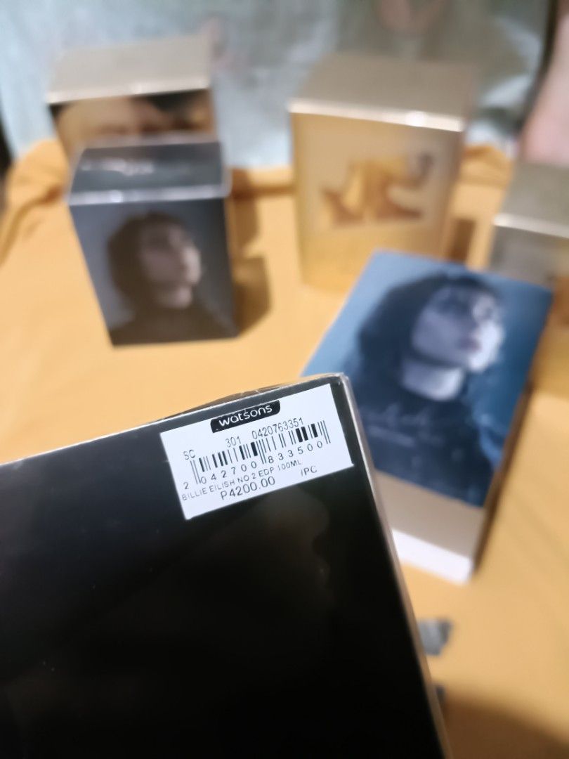 ORIGINAL Eilish No. 2 Eau de Parfum by Billie Eilish 100ml (BLACK) (Category: Fragrance & Deodorants) located in Pasay City. Submitted by declutterwifmeee (Listing ID 1354804110, Image 2). Description: Eilish No. 2 is an alluring Woody Floral fragrance featuring notes of apple blossom, wild wet poppy flowers, and palo santo. Top Notes Italian Bergamot, Apple Blossom, Incense Middle Notes Papyrus, Black Pepper, Wild Poppy Flower Base Notes Palo Sa