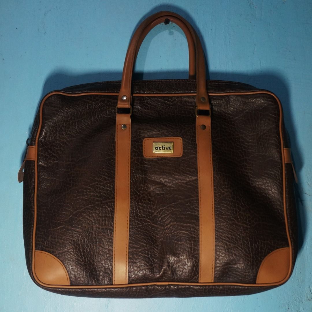 Brown Laptop Bag (Category: Laptop Bags & Sleeves) located in Taguig. Submitted by tcstuff (Listing ID 1354881456, Image 1). Description: Length: 14 in x 11 in x 2.3 in Material: PU Leather Lining: Vinyl Newly cleaned. Newly polished metal hardware. Payment Method: GCash or LBC Cash on Delivery /Cash on Pickup .