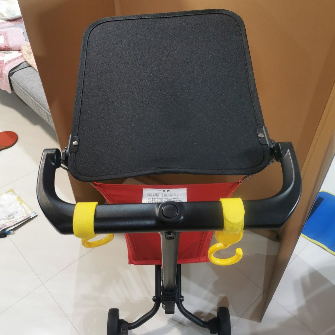 Folder stroller (Category: Strollers) located in Singapore. Submitted by stevejy (Listing ID 1354850331, Image 4). Description: Foldable red colour stroller Cabin Size 57cm x 32cm x 14 com 2.8 kg when folded Bottom footrest come with a blinking light when press Suitable for user weight up to 22 kg One hand folding Include an IKEA DIMPA storage bag for carry out.