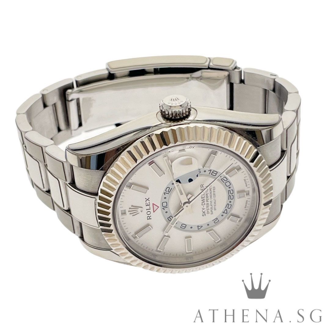 ROLEX ROLESOR OYSTER PERPETUAL ANNUAL CALENDAR GMT SKY DWELLER “AN” SERIES “WHITE DIAL” WITH CERT DATED (04/2019) 326934 (Category: Watches) located in Singapore. Submitted by athenawatches (Listing ID 1354806057, Image 2). Description: WLWRL_1736 Brand Rolex Model 326934 Series Alpha Numeric Colour of Dial White Dial with Luminescent Index Markers Bezel 18K White Gold Fluted, Bidirectional Rotatable Rolex Ring Command Bezel Case Diameter 42mm Ca