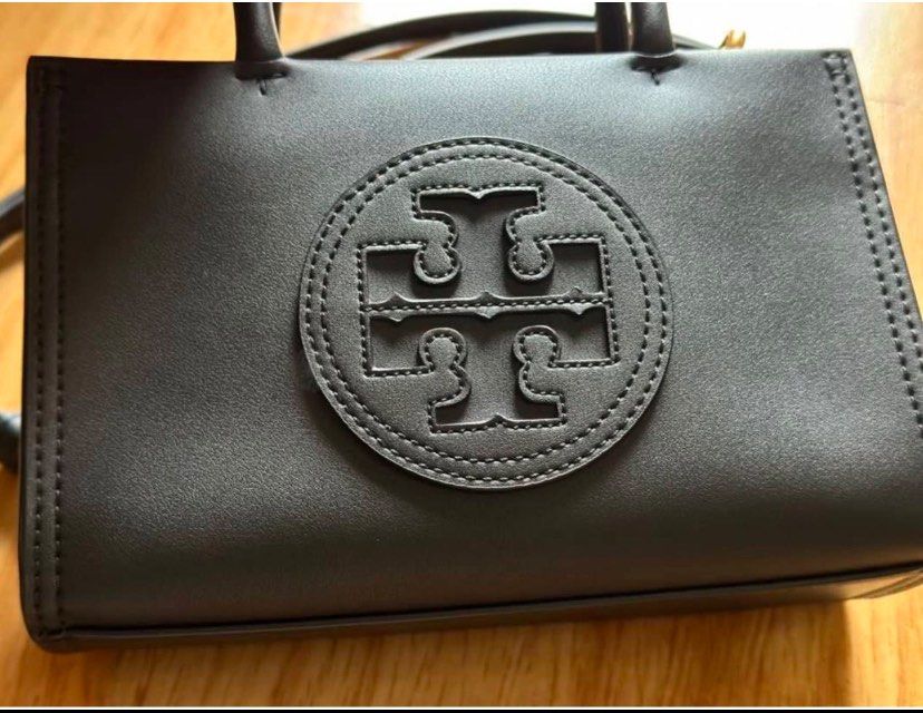 Tory Burch Mini Ella Bio Tote(Black) (Category: Luxury Bags & Wallets) located in Antipolo. Submitted by chaelvin29 (Listing ID 1354895011, Image 2). Description: 🌸Personal Preloved🌸 Tory Burch Mini Ella Bio Tote(Black) Height: 4.9” (12.5cm); length: 7.3” (18.5cm); depth: 2.8” (7cm) Outer shell: BioFabbrica Bio-Tex™ (64% USDA-certified bio-based content) Cotton herringbone lining Bridge with magnetic snap closure; snaps on gussets Top handles w
