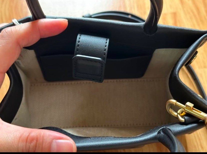 Tory Burch Mini Ella Bio Tote(Black) (Category: Luxury Bags & Wallets) located in Antipolo. Submitted by chaelvin29 (Listing ID 1354895011, Image 3). Description: 🌸Personal Preloved🌸 Tory Burch Mini Ella Bio Tote(Black) Height: 4.9” (12.5cm); length: 7.3” (18.5cm); depth: 2.8” (7cm) Outer shell: BioFabbrica Bio-Tex™ (64% USDA-certified bio-based content) Cotton herringbone lining Bridge with magnetic snap closure; snaps on gussets Top handles w