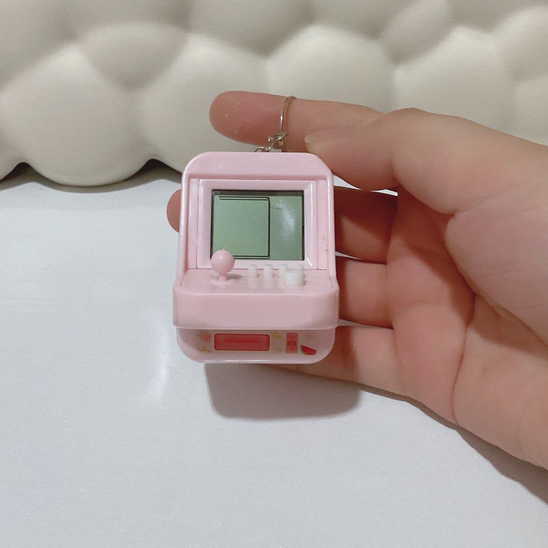 [Trinkets] Mini Pink Arcade Keychain (Playable) (Category: Character Goods) located in Caloocan City. Submitted by meigiselle (Listing ID 1354844153, Image 1). Description: - will buy batteries - with games and working buttons - can change the ring into a ball chain upon request .
