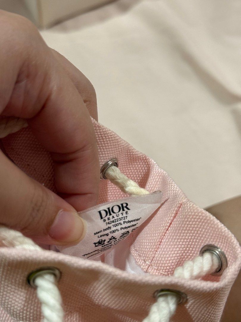 DIOR beaute pouch (Category: Luxury Bags & Wallets) located in Quezon City. Submitted by millennialdeclutterer (Listing ID 1355013214, Image 3). Description: DIOR beaute pouch in color pink. Has minor stains as I’ve used it as a make up pouch. Only used twice (for travel). Got this at DIOR beauty podium branch😊.