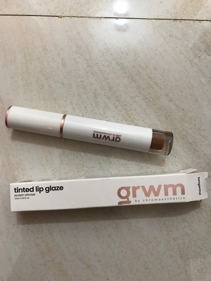 GRWM Tinted Lip Glaze (Tangerine) (Category: Makeup) located in Pasay City. Submitted by spongefinds (Listing ID 1354983585, Image 1). Description: rfs: picked out the wrong color Box opened but not the lipstick itself.