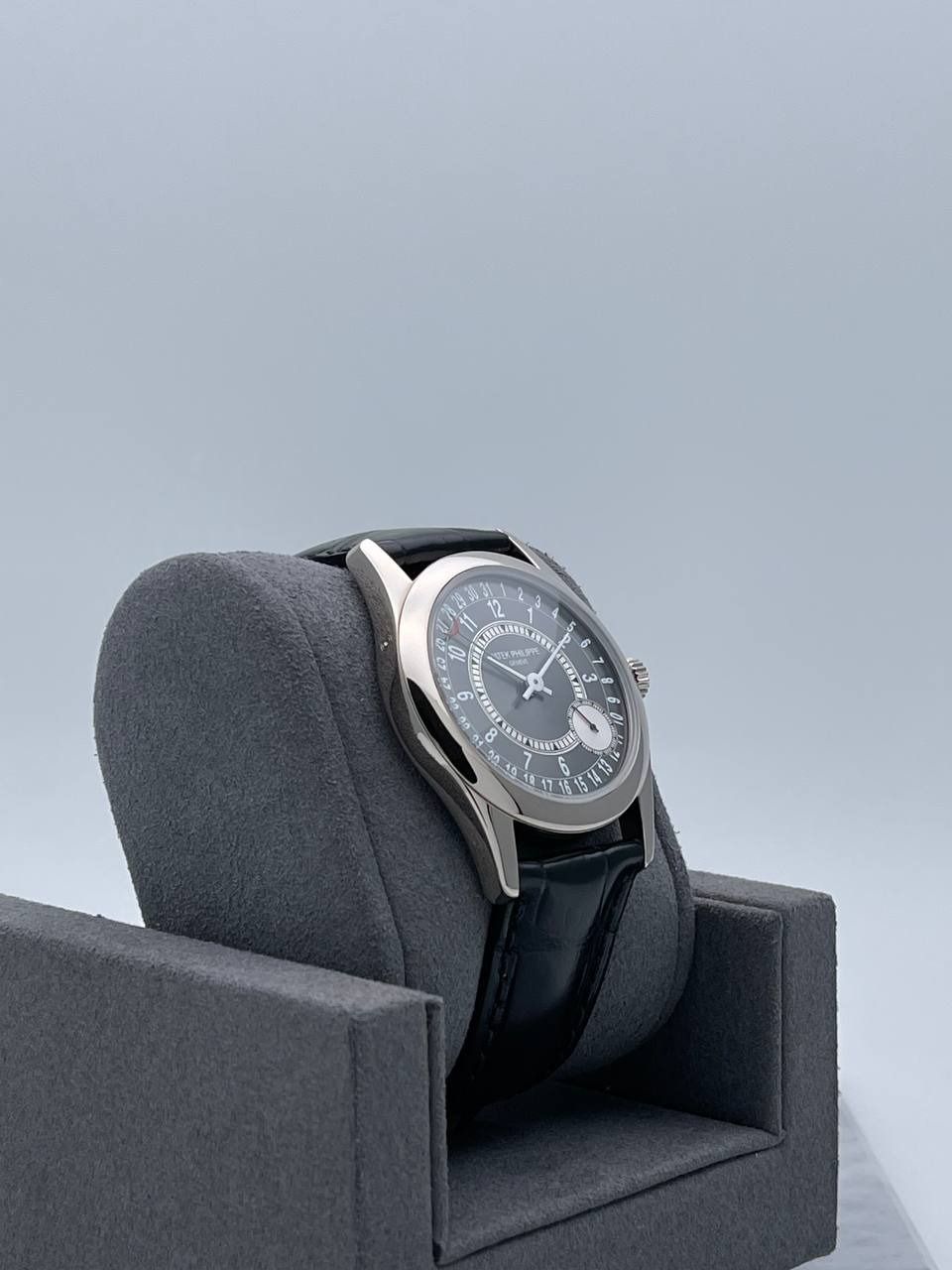 Patek Philippe Calatrava 6000G-010 • 2014 • 📦 & 📄 (Category: Watches) located in Singapore. Submitted by timetells (Listing ID 1355233616, Image 3). Description: Brand: Patek Philippe Model: Calatrava Reference Number: 6000G-010 Year: 2014 Case Size: 37mm Material: 18k White Gold Bezel: Fixed 18k White Gold Dial: Anthracite Grey with Arabic Numerals Strap: Brown Leather Strap with 18k White Gold Fold Over Clasp Power Reserve: 48 hours Movement: