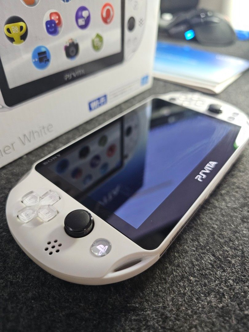 PS Vita Slim Glacier White (Category: PlayStation) located in Paranaque City. Submitted by john020497 (Listing ID 1355278433, Image 2). Description: - Good as new. With very minimal hairline scratches. - Complete with box, manuals, official sony memory card and charger. - Can be modded upom request. Bacoor, Cavite. Delivery via Lalamove/Grab/LBC..