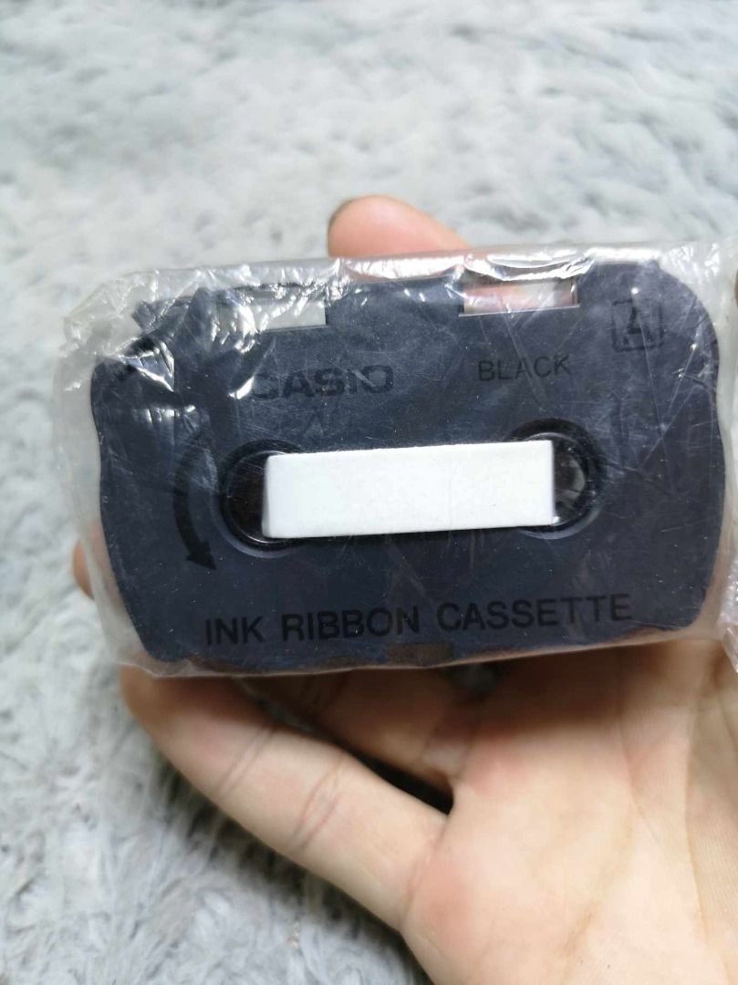 Black ink Ribbon Cassette (Category: Voice Recorders) located in Santa Cruz. Submitted by jmy_surplus.2 (Listing ID 1350987224, Image 1). Description: Size ; L - 2 W - 2 Color ; Black Type ; Tape Brand ; No brand Material ; Plastic Style ; Black In Ribbon cassette LG 105 JMY 4.