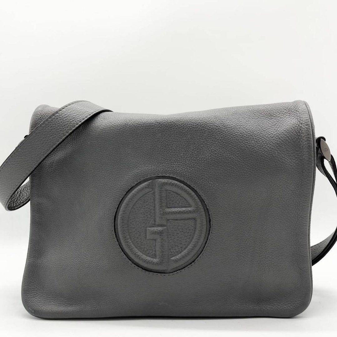 Giorgio Armani Messenger Bag (Category: Luxury Bags & Wallets) located in Baguio. Submitted by thrift_saver07 (Listing ID 1350949926, Image 1). Description: Dark Grey Magnetic Flap Main Conpartment Inner Zip Pocket Zipper 2 compartment Magnetic back compartment Signs of usage Authentic 100% Selling low Giorgio Armani navy calf leather It's a body bag The GA logo is embossed on the leather of the front cover as an accent. This bag is made of soft 