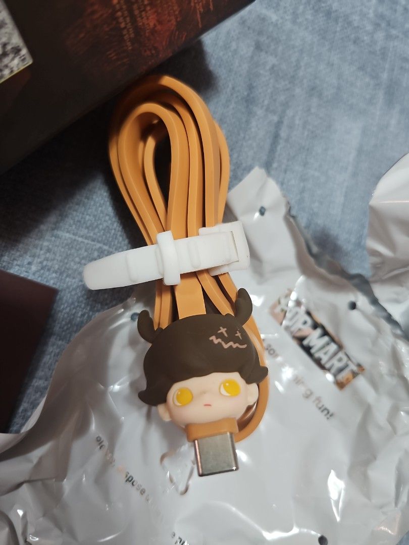 Pop Mart [tan/brown] Dimoo USB to Type C cable (Category: Chargers & Cables) located in Las Pinas. Submitted by gl3nndita (Listing ID 1350943177, Image 2). Description: Pop Mart Original USB to Type C cable Dimoo No One's Gonna Sleep Tonight series Character: Deer Colorway: tan cord, brown face character Complete: box opened from top, product leaflet, open / unsealed foil.