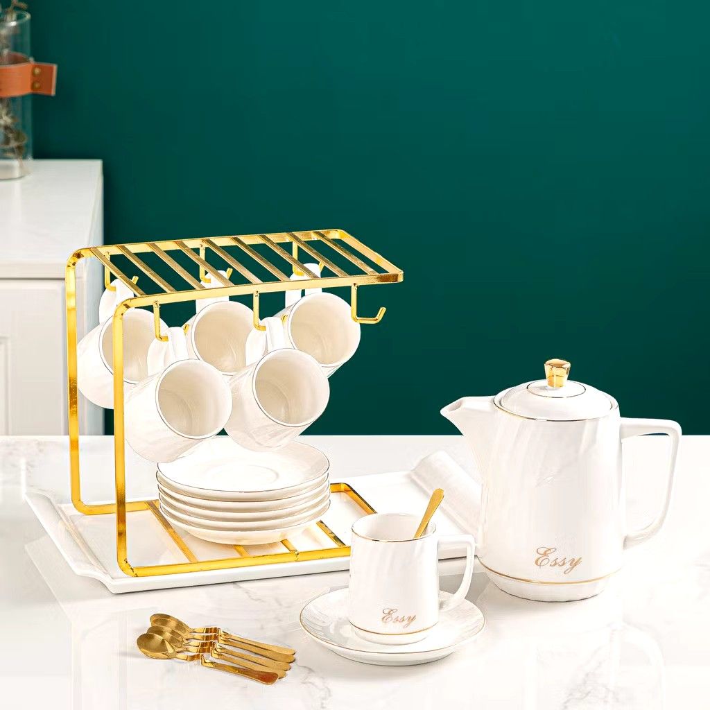 14 pcs Luxury Elegant Tea pot and Tea cups Set (Category: Coffee & Tea Tableware) located in Manila. Submitted by cristytah (Listing ID 1351125720, Image 1). Description: Set includes: 6 cups, 6 plate, 1 Gold rack, 1 pot and 6 free spoon Measurements: ● Teacup-220mL 6.2x8.5cm ● Teapot-1150mL 9.6x19cm Dish-14x1.8cm ● Rack-24x15.2x22.5cm Perfect as a gift or to use at home! Quality+Aesthetics Gift Box.