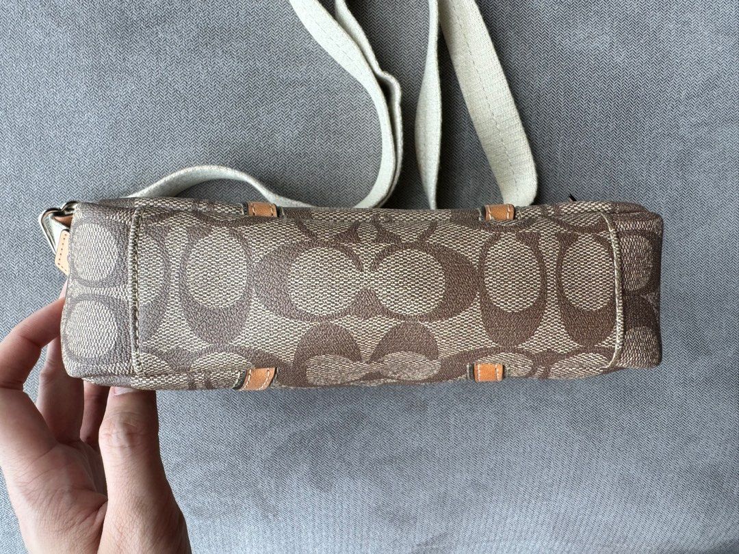 Coach Signature Camera Bag (Preloved) (Category: Luxury Bags & Wallets) located in Quezon City. Submitted by __J__ (Listing ID 1351221463, Image 3). Description: Preloved original Coach Signature Camera Crossbody Bag. It has a front pocket, internal zipper pocket, and an adjustable strap. Condition: Used with care. Overall, bag is in great condition but there are flaws on the strap (last photo). RFS: Need funds (selling on behalf of a relative) L