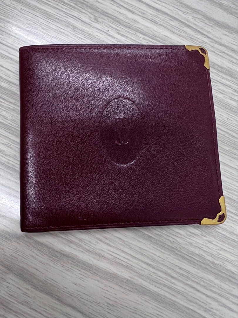 Authentic Cartier compact Wallet (Category: Luxury Bags & Wallets) located in Cagayan de Oro. Submitted by riggstuffs (Listing ID 1351327425, Image 1). Description: ➡️ Authentic Cartier Compact Wallet ➡️ calfskin material in burgundy color ➡️ exterior is in good condition with the embossed logo ➡️ Interior has 3 bill compartments ➡️ Rank A-AB in condition Disclaimer: Riggstuffs is not associated or affiliated with the brand posted. All copyrights