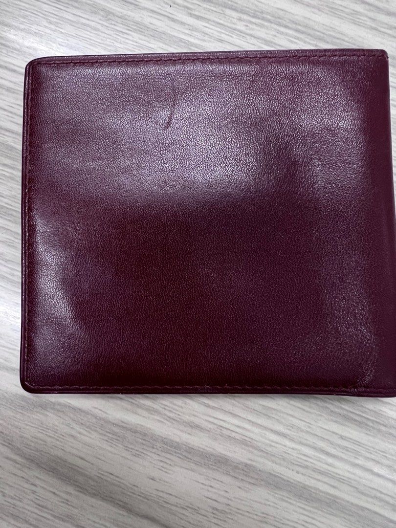 Authentic Cartier compact Wallet (Category: Luxury Bags & Wallets) located in Cagayan de Oro. Submitted by riggstuffs (Listing ID 1351327425, Image 2). Description: ➡️ Authentic Cartier Compact Wallet ➡️ calfskin material in burgundy color ➡️ exterior is in good condition with the embossed logo ➡️ Interior has 3 bill compartments ➡️ Rank A-AB in condition Disclaimer: Riggstuffs is not associated or affiliated with the brand posted. All copyrights
