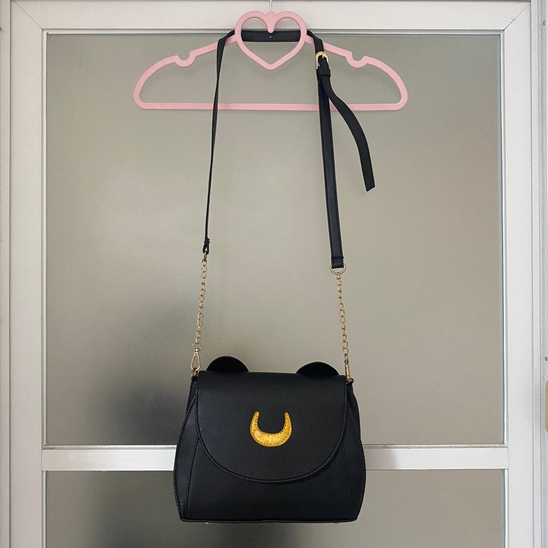 Sailor Moon Luna cat bag [Pre-loved] (Category: Cross-body Bags) located in San Jose del Monte. Submitted by hellocutease (Listing ID 1351316992, Image 1). Description: Flaw on moon (discoloration) NOT LICENSED SAILOR MOON MERCH.