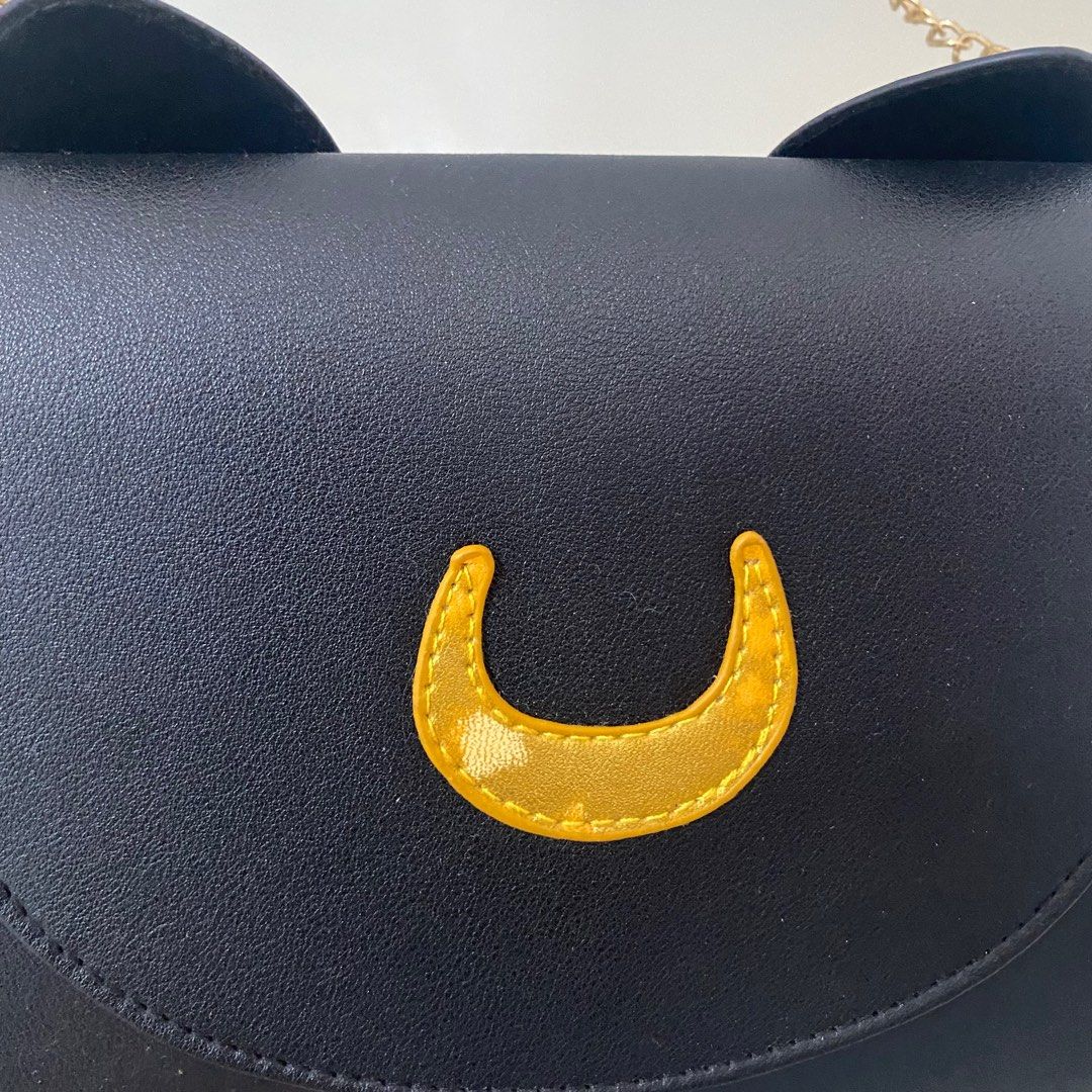Sailor Moon Luna cat bag [Pre-loved] (Category: Cross-body Bags) located in San Jose del Monte. Submitted by hellocutease (Listing ID 1351316992, Image 2). Description: Flaw on moon (discoloration) NOT LICENSED SAILOR MOON MERCH.