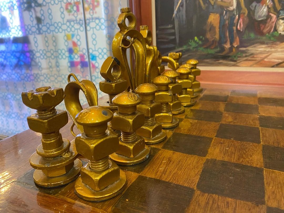 Custom made chess table with recycled bolts and nuts (Category: Other Home Furniture) located in Cavite. Submitted by mycoachvault (Listing ID 1351564436, Image 3). Description: ♟️On hand. Can be shipped asap. ♟️Negotiable. -- ♟️Custom Made Chess table with recycled bolt and nuts as chess pieces. ♟️Table is made of steel, chairs and chessboard are made of wood. ♟️This was made during the pandemic my Meralco employees and it was auctioned for char