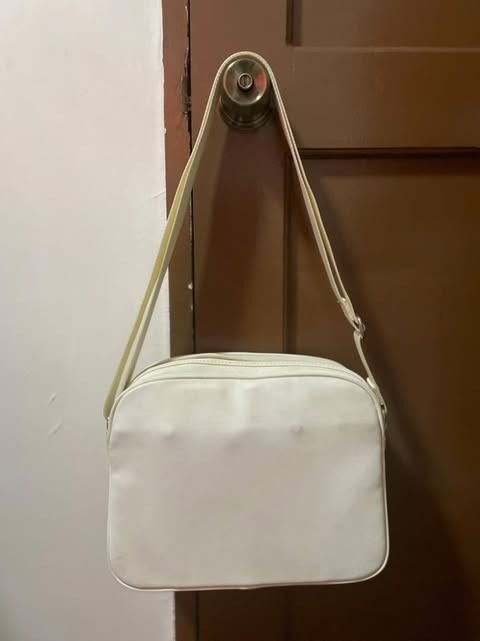 Authentic Lacoste White Cross-bag (Category: Luxury Bags & Wallets) located in Muntinlupa City. Submitted by d_everythingsnice (Listing ID 1351643852, Image 2). Description: Authentic Lacoste Cross Bag. - White in color - has black marks but could be wash or have it done by professional (please refer to the photos) - Good condition ang inner part - NO OTHER ISSUES aside sa nasa PHOTOS - Manage your expectations.
