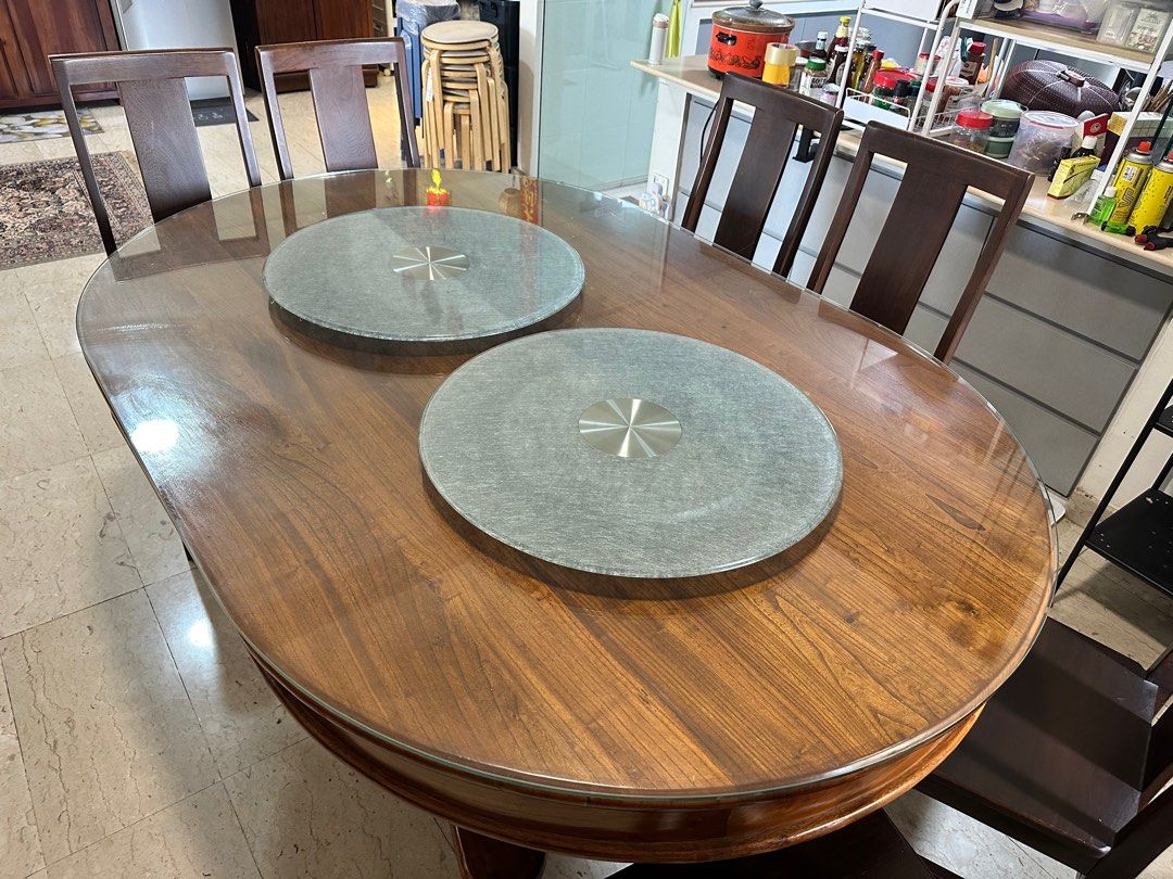 Solid Wood Dining Table (Category: Tables & Sets) located in Singapore. Submitted by goldencloud_5cb8f5 (Listing ID 1350867437, Image 1). Description: 1. Oval shaped solid teak dining table 2. 180cm (L) x 125cm (B) x 80 cm (H) 3. Tempered glass top 4. Lazy Susan 5. 6 solid wood chairs Arrange for own delivery .
