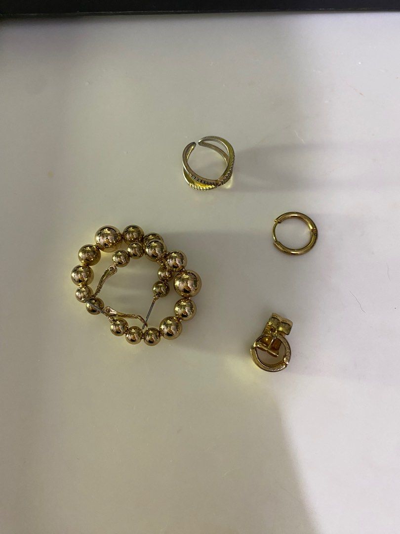 Gold Jewelry Set: Earrings & Ring accessories (Category: Earrings) located in Quezon City. Submitted by segfcarts (Listing ID 1352091466, Image 1). Description: Set of gold accessories: 3 earrings & 1 ring. Hoop earrings, adjustable ring.