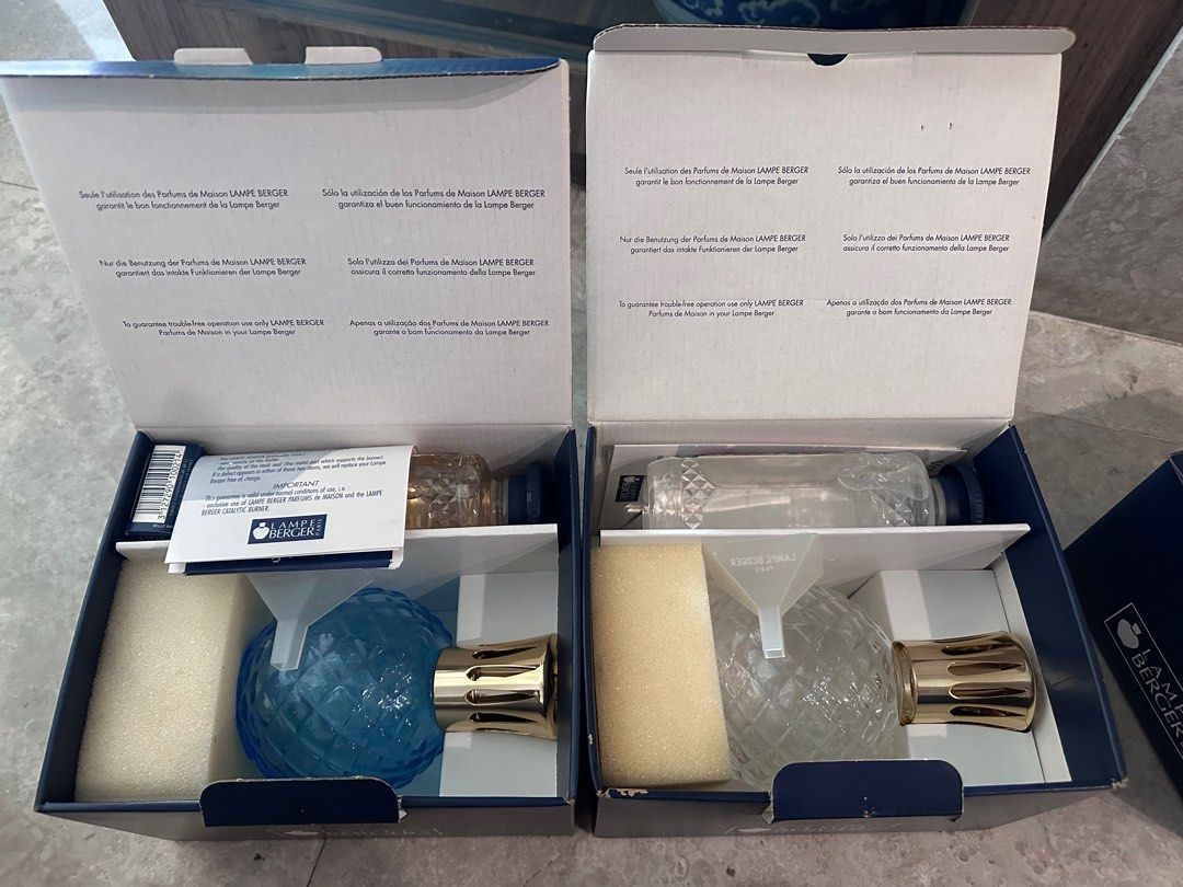 Lampe Berger Diffuser (Category: Home Fragrance) located in Singapore. Submitted by pwnny (Listing ID 1352025776, Image 1). Description: Lampe Berger Blue bottle with Chypre (500 ml) White bottle with Lavende (500ml) Full set with bottle, wick, 500 ml perfume oil, funnel Each set is $50.