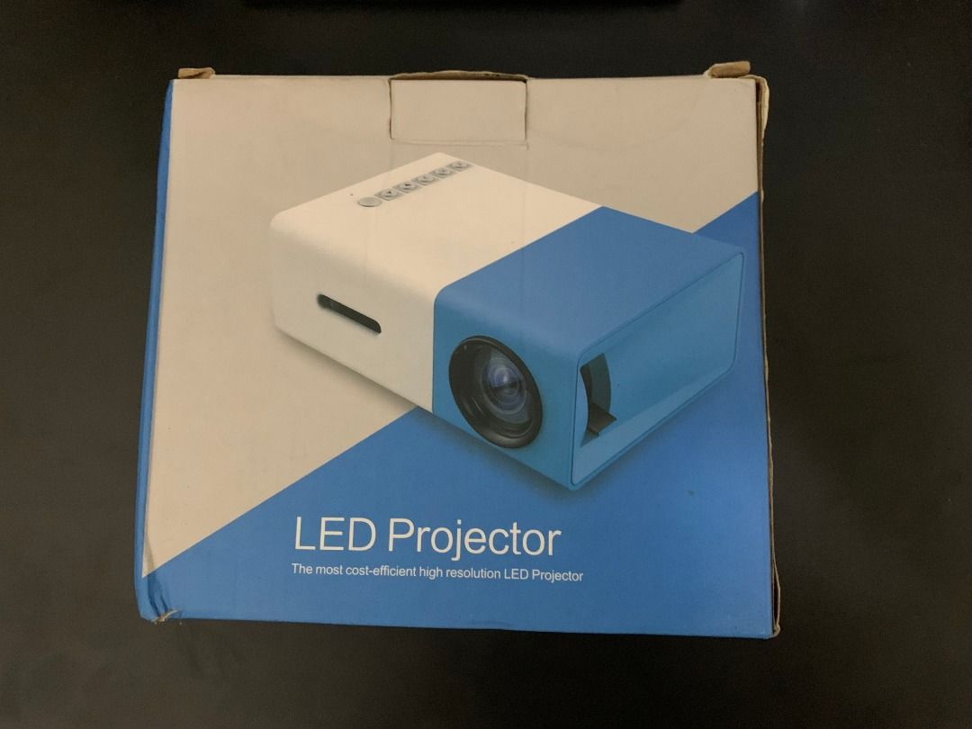 Mini Portable LED Projector (Category: Projectors) located in Paranaque City. Submitted by sourempire (Listing ID 1351969527, Image 2). Description: Compact Projector Box is the only thing tattered, projector itself was used once. Comes with Projector Remote, Power Cable and AV cable. Has HDMI, USB and Micro SD ports..