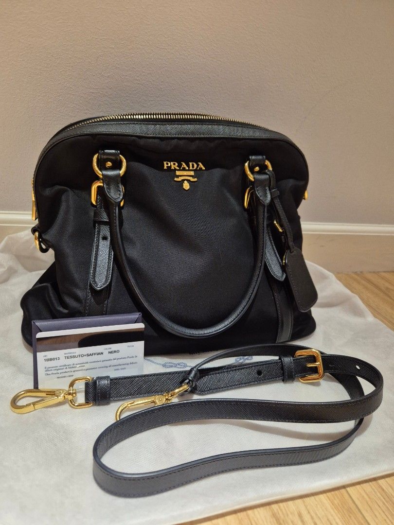 Prada Tessuto Nylon Dome Bag (Category: Luxury Bags & Wallets) located in Paranaque City. Submitted by happyfindsbyc (Listing ID 1352119865, Image 1). Description: Condition: 10/10; Used thrice only Complete with cards and dustbag. Bought in HK. RFS: Decluttering.