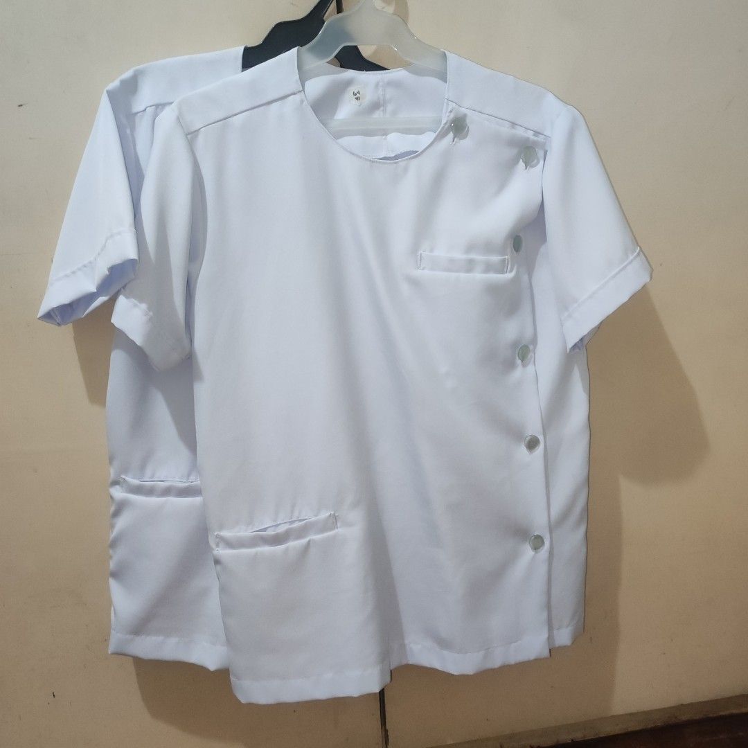 White medical course uniform (round neck) (set) (Category: Formal Shirts) located in Quezon City. Submitted by chaengramjl (Listing ID 1352115388, Image 1). Description: - white - rounded neck - left sided buttons length: 64 width: 41 stock: 2 mop: gcash, cimb, seabank mod: sdd, jnt loc: qc.