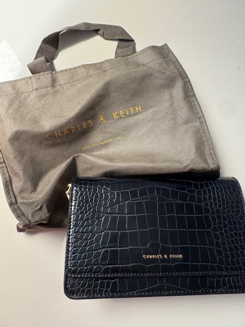 Charles & Keith Black Bag (Category: Clutches) located in Davao. Submitted by Chelly (Listing ID 1355651987, Image 1). Description: ✨Slightly used ✨With Dust Bag ✨Nakatago na lang kaya may slight pag balat sa loob bg bag (as seen on the photos) .